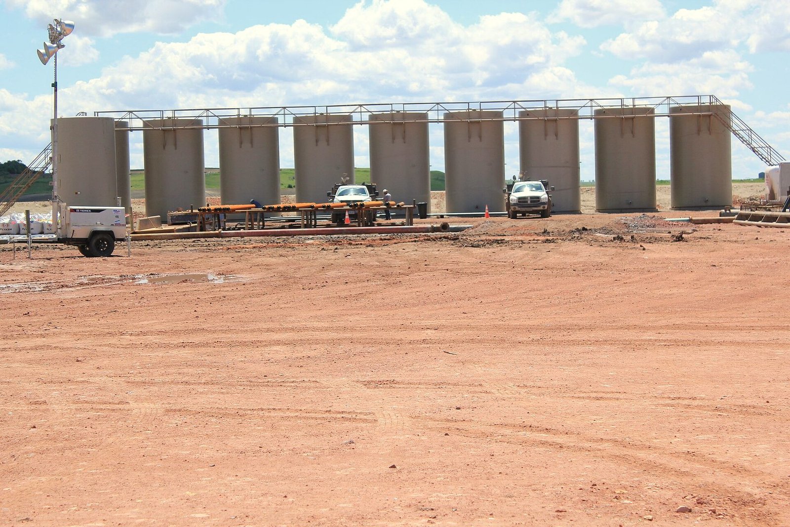 A row of oil storage tanks forming a tank battery